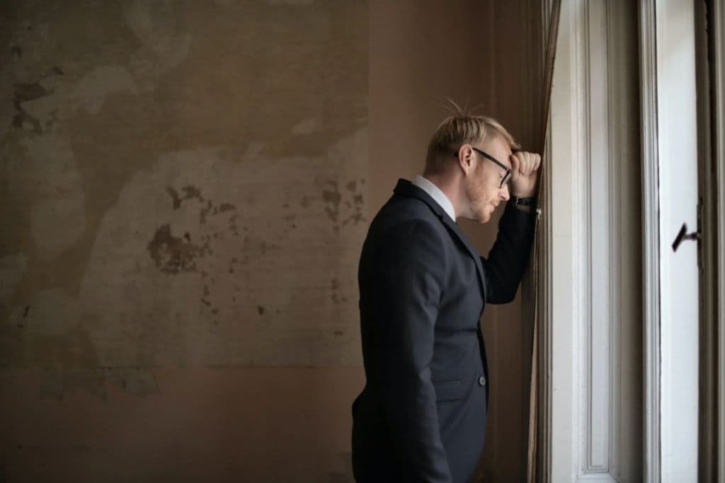 Man grieving the loss of trade on the stock market - TradeZella